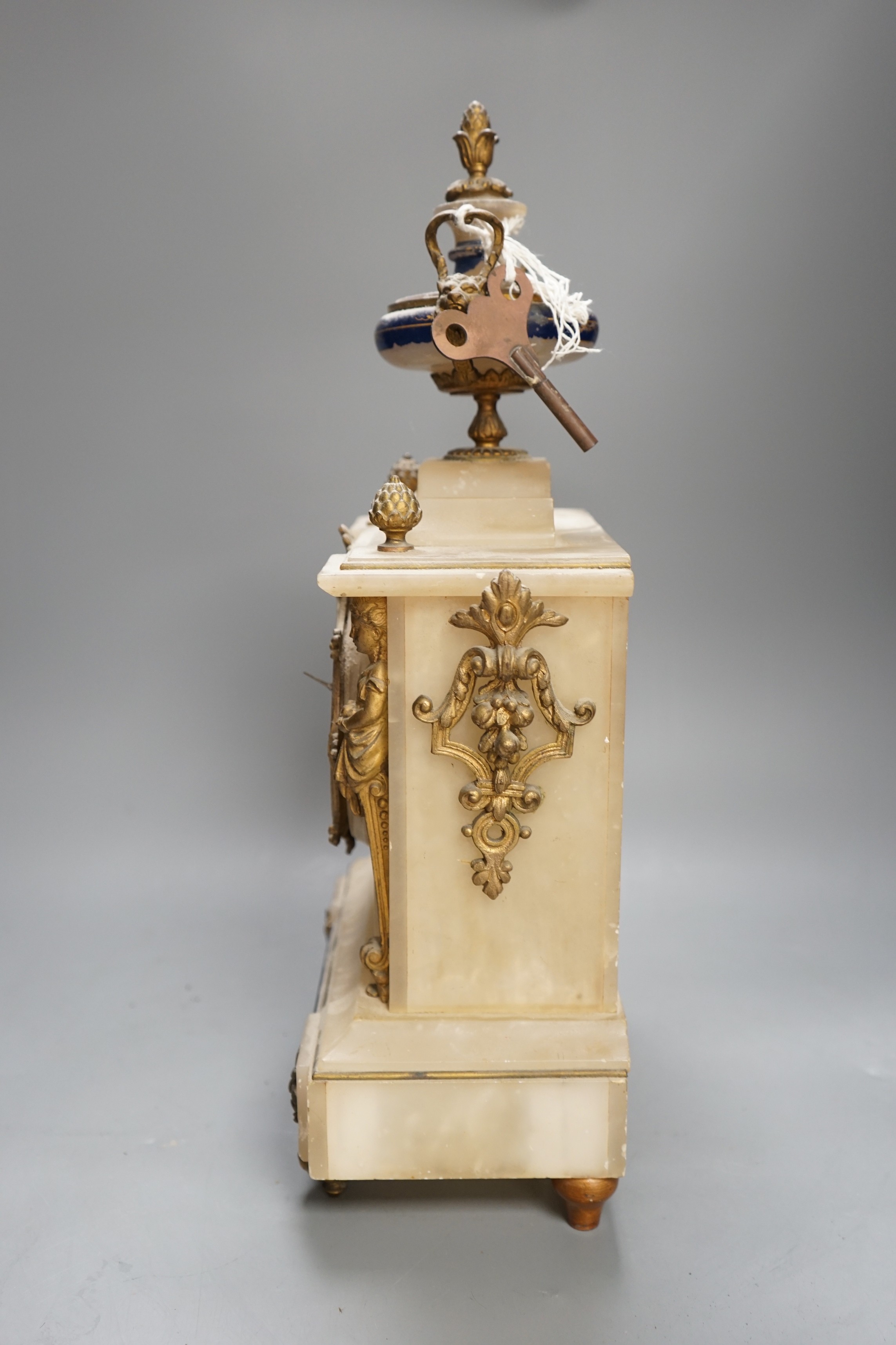 A French alabaster gilt mounted mantel clock, 44cms high